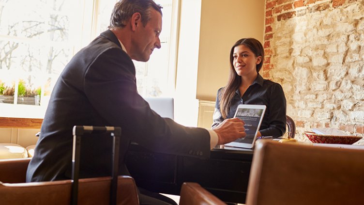 A male and female employee sitting in a office cabin at premier technology workplace