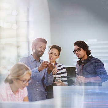 Office colleagues looking at a mobile