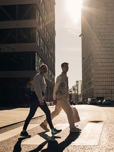 Two men are walking on street