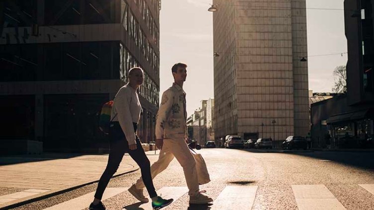 Two men are walking on street