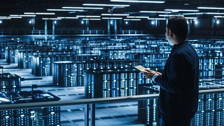 facilities manager inspects servers in data colocation center