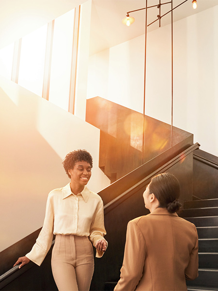 Two women talking on staircase