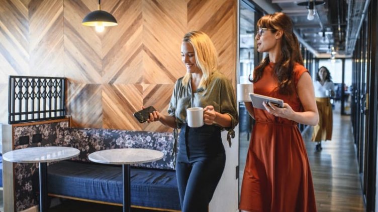 Picture of two employees of JLL talking and having coffee together