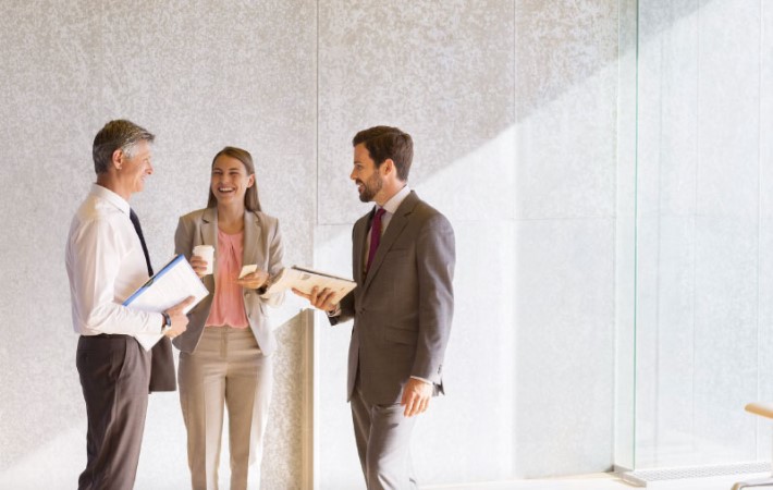 Office employees are having conversation and laughing