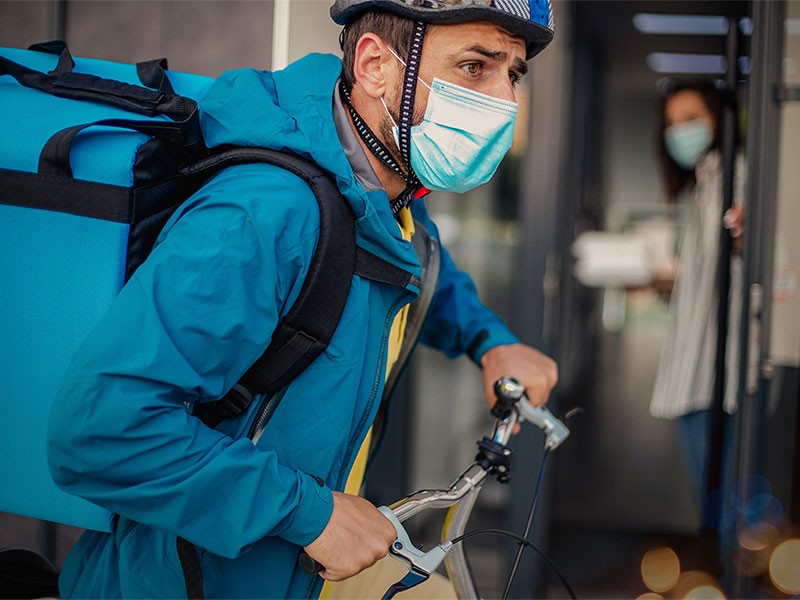 Men delivering the grocery and food items in bicycle during pandemic