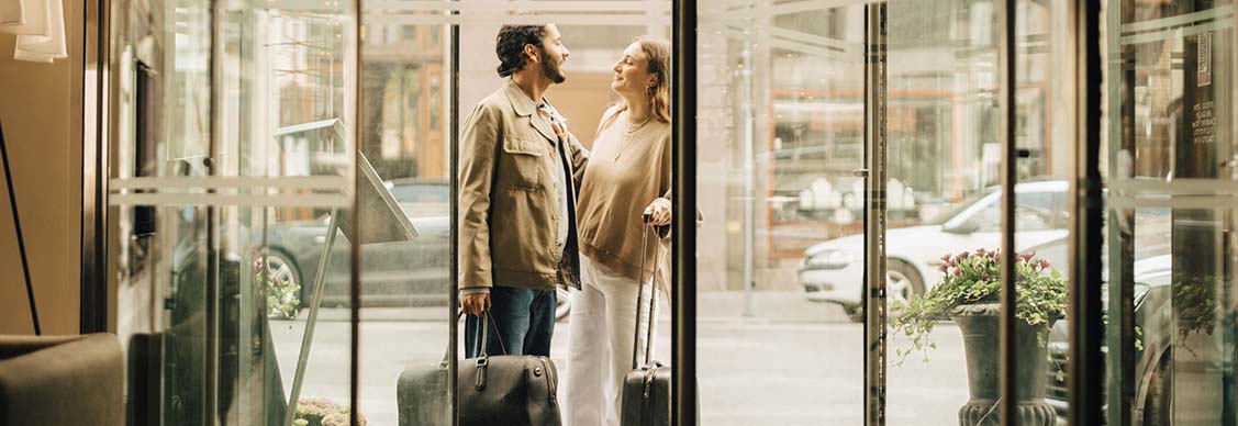 A man women holding bags and looking