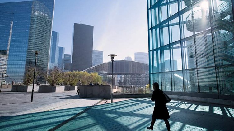 A women walking outside office building