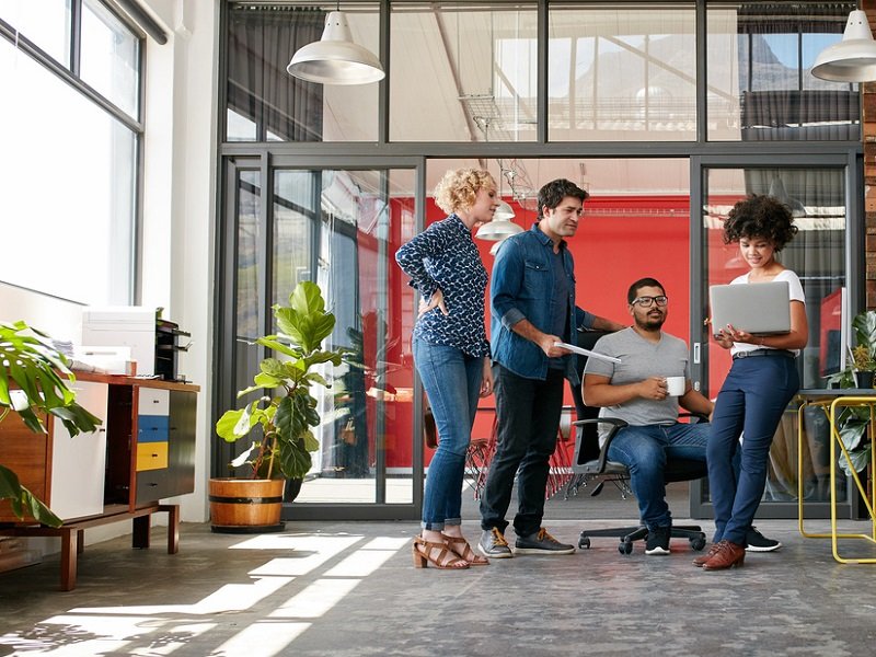 Coworkers meet in eco-friendly workspace